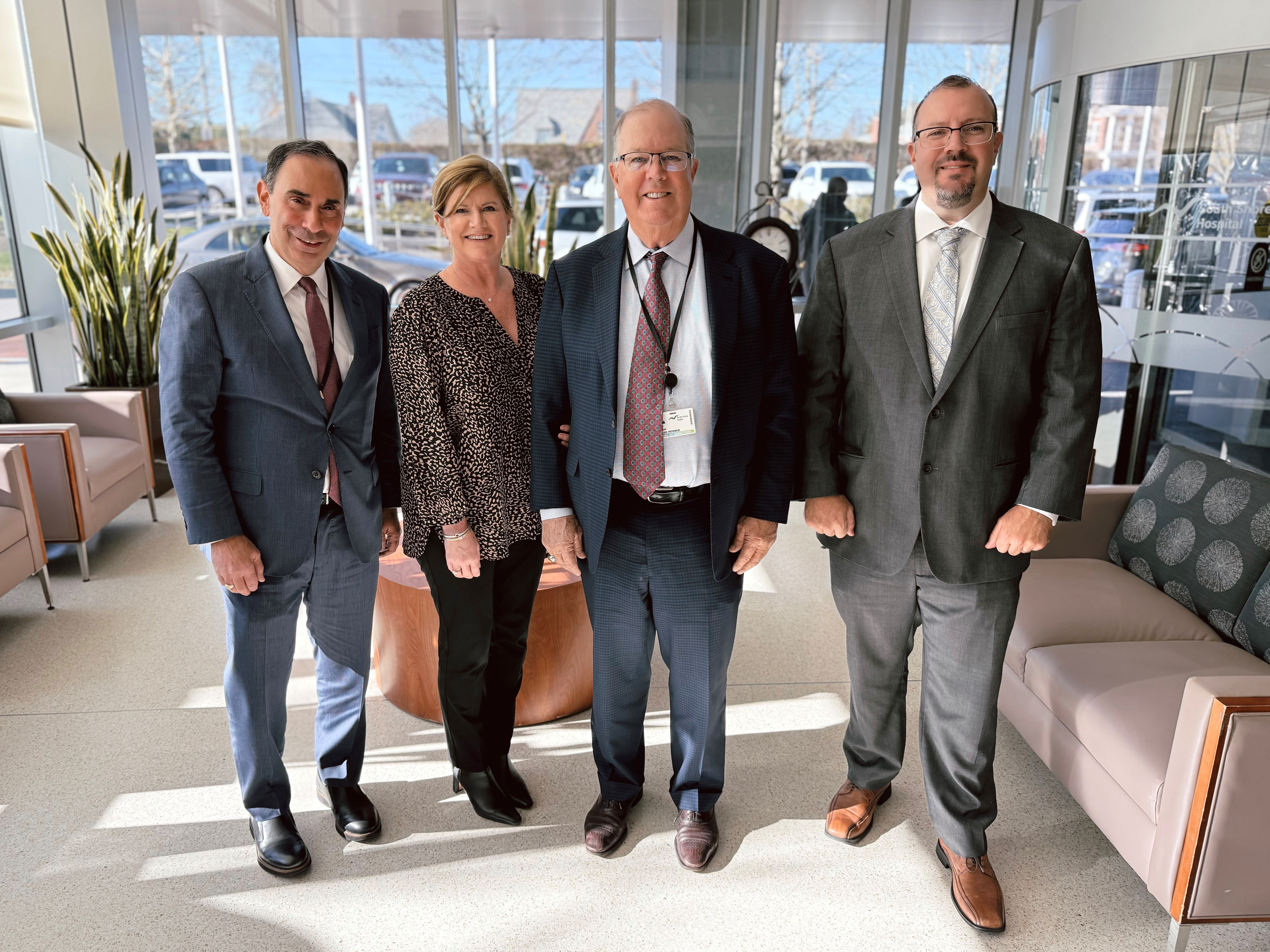 Alan McKim and members of his family pose for a photo with Allen Smith at South Shore Hospital.