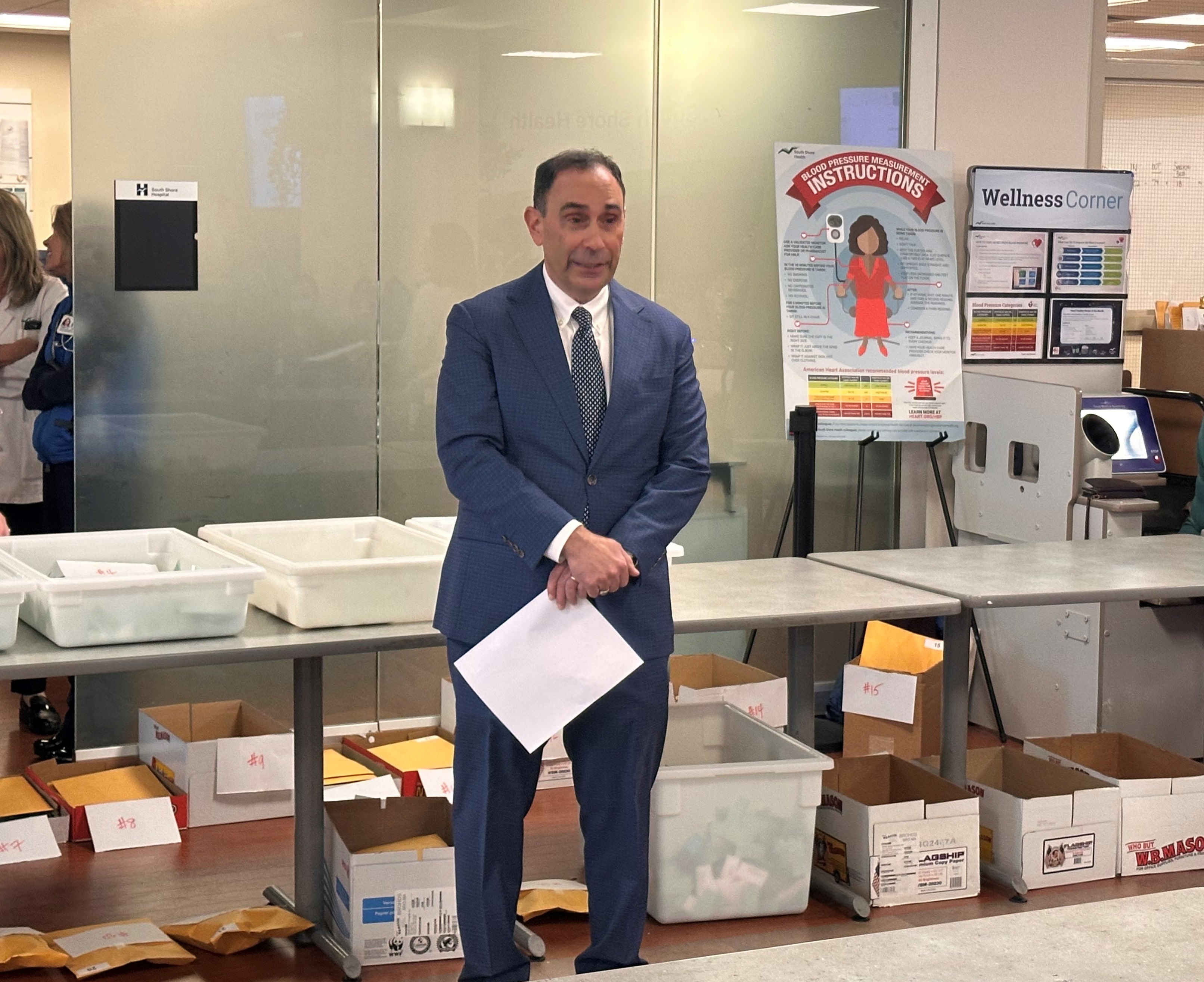 Allen Smith, MD, MS speaks to the gathered crowd prior to the holiday basket raffle.