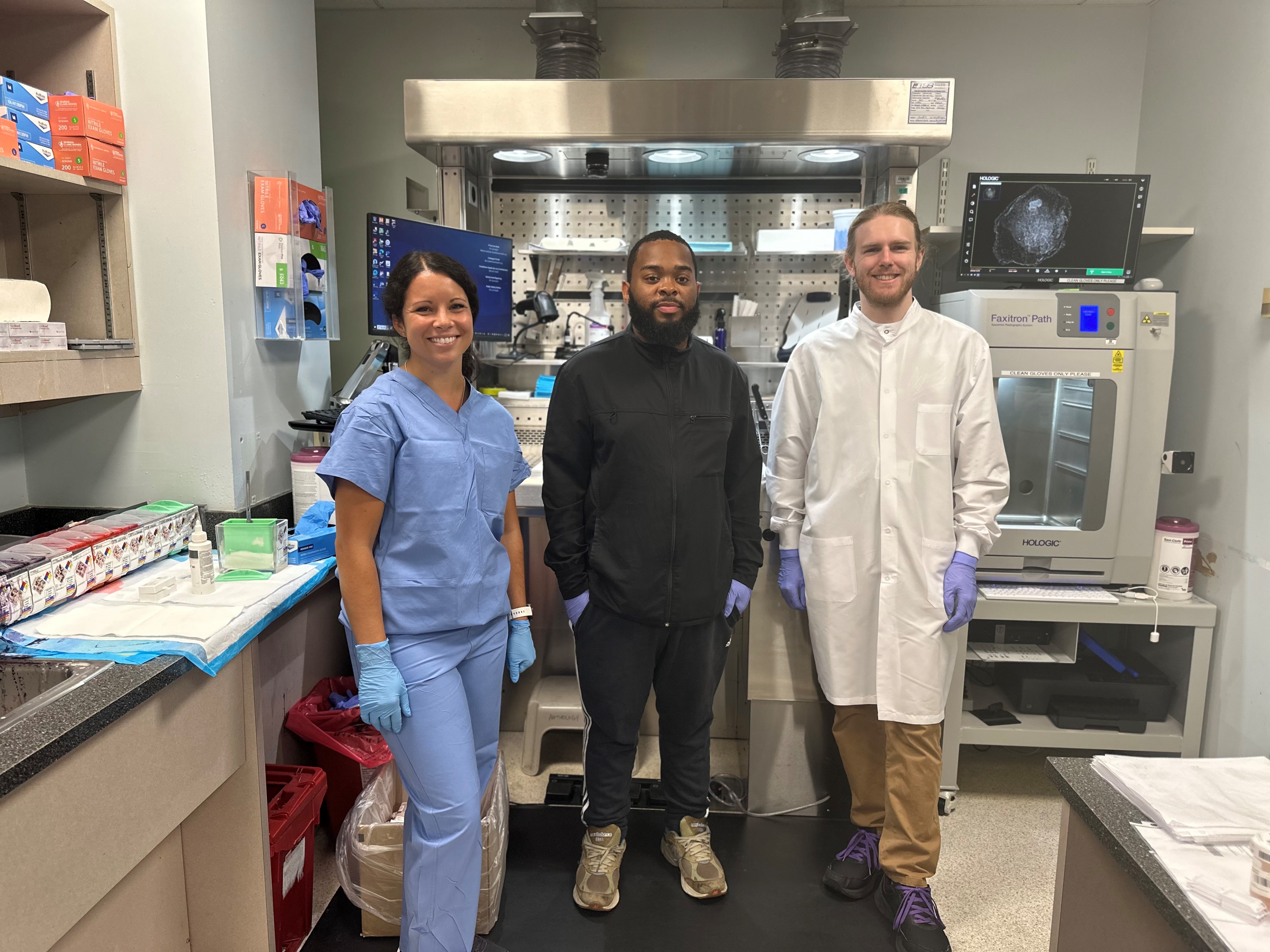 Lab colleagues stand in front of one of the new grossing stations