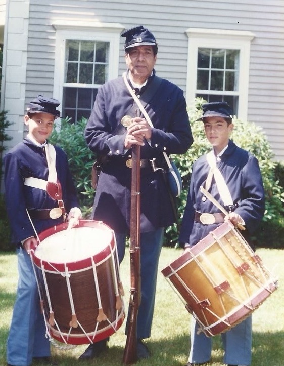 Black man and his two sons dressed in Civil War uniforms