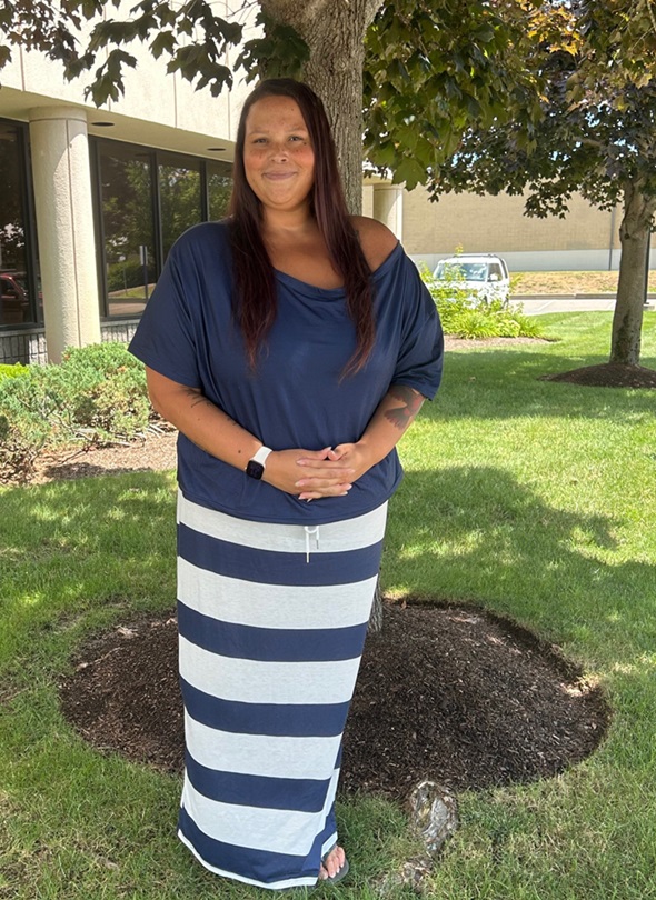 Donyelle Carmody poses outside an office building