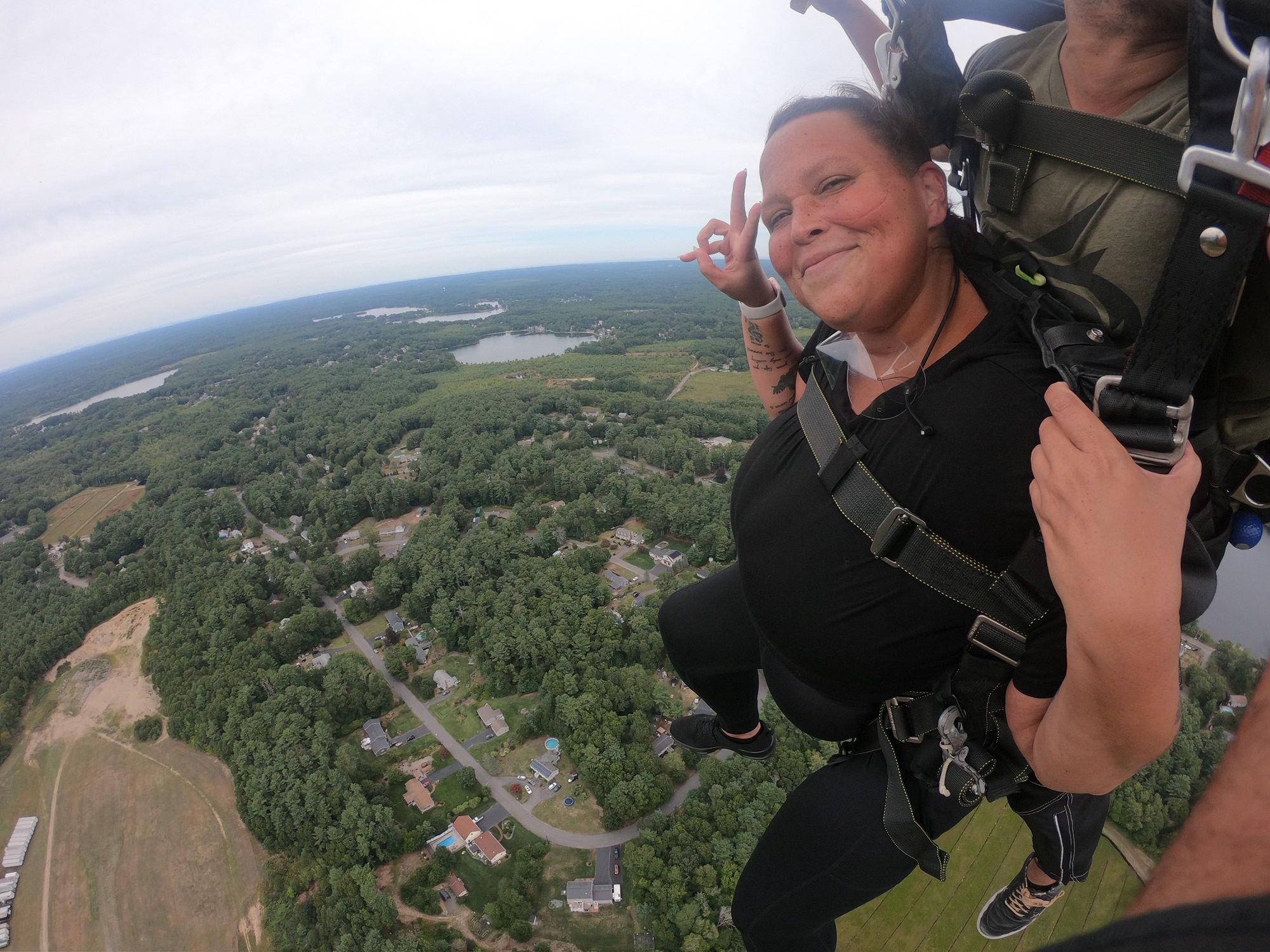 A woman doing a skydiving jump with an instructor