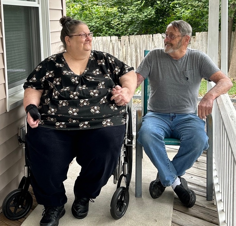 Gigi and Bill Barnes sitting on their porch