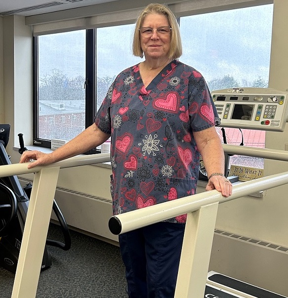 A woman standing on a treadmill at cardiac rehab
