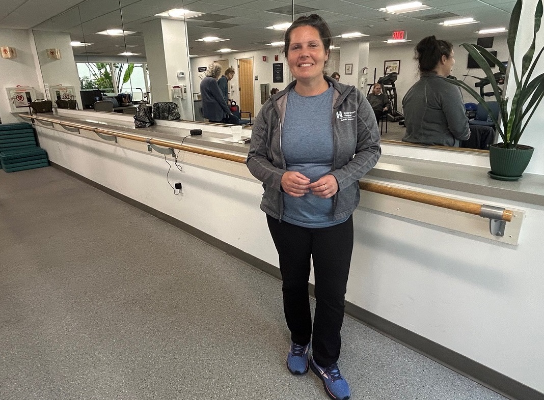 Community Exercise Manager Jennifer Logan stands by the mirror in class