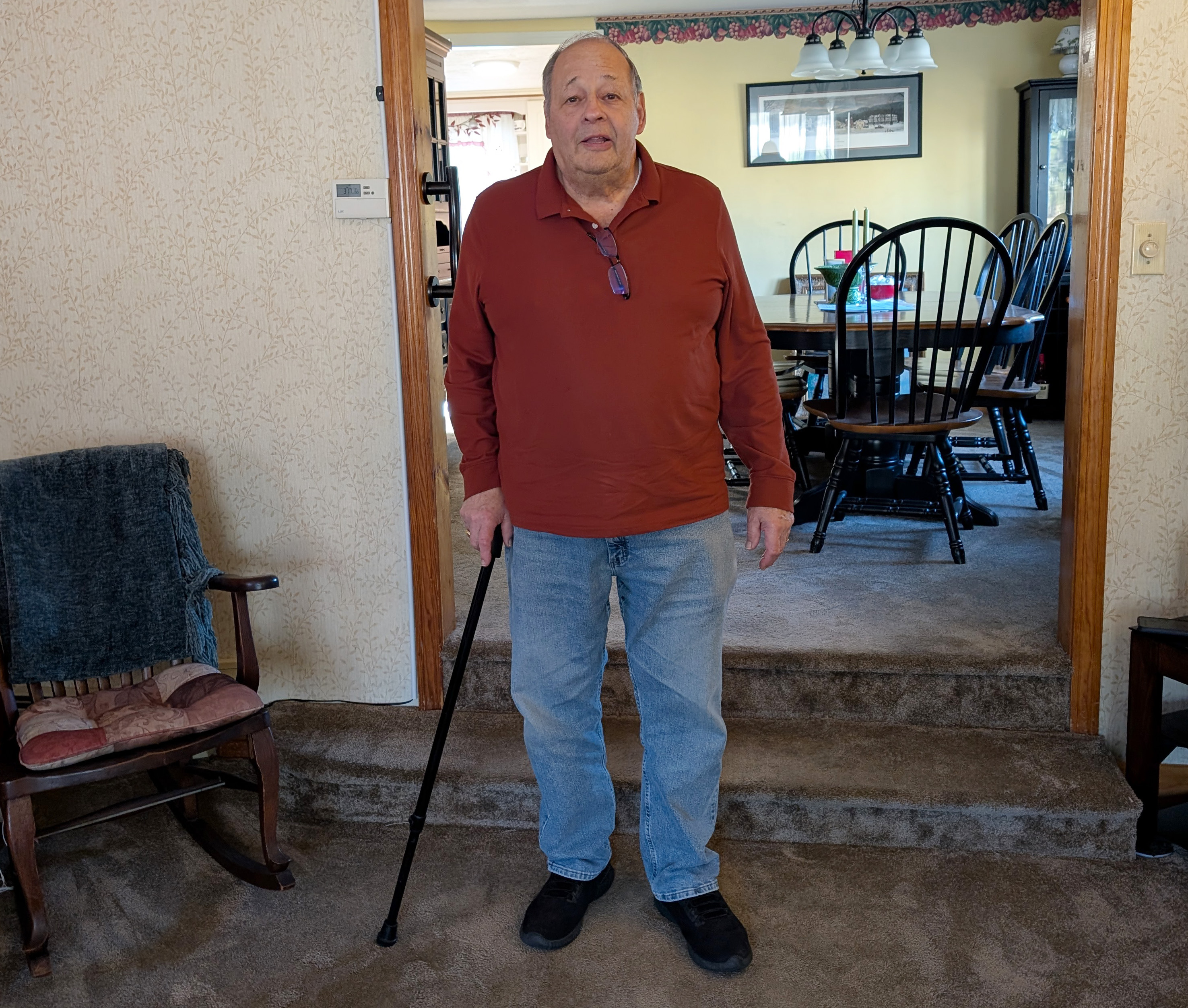 John of Rockland poses for a photo in his living room after an at-home outpatient rehab appointment.