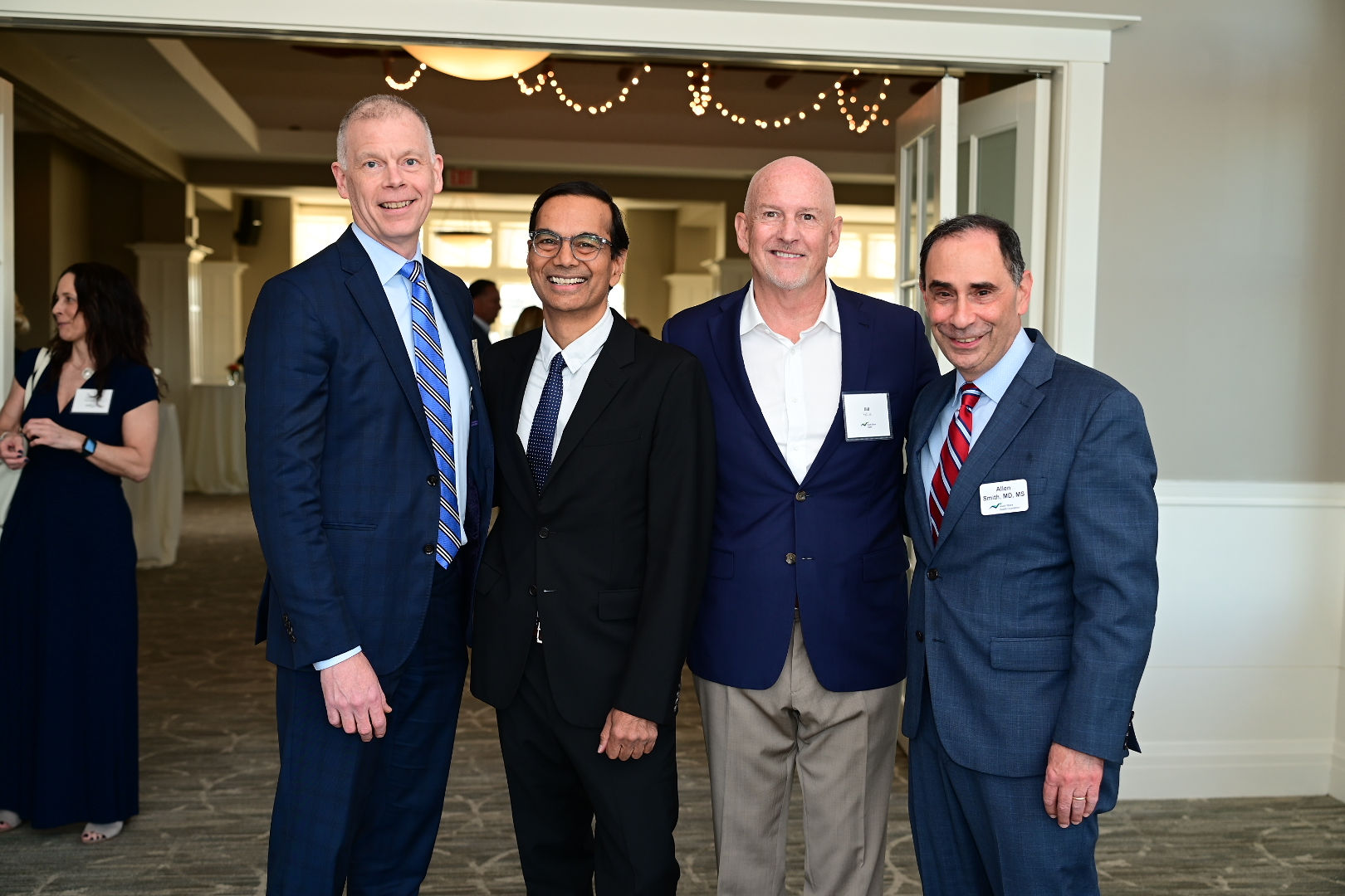 Jason Tracy, Baba Shetty, Bill Fallon, and Allen Smith pose for a photo.