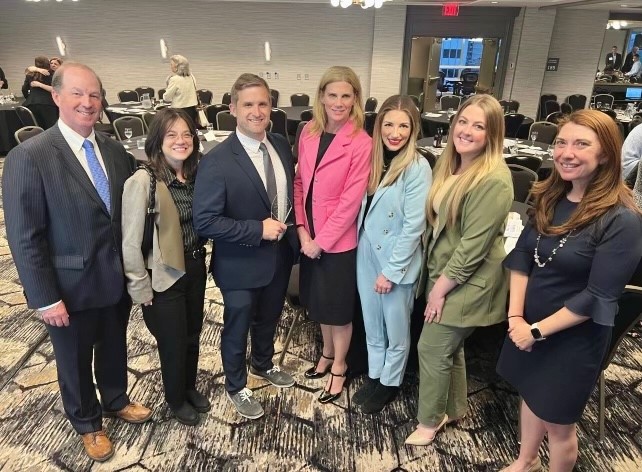 Colleagues from South Shore Health's Legal Department pose for a group photo with Lucas Hamory after he received his award.
