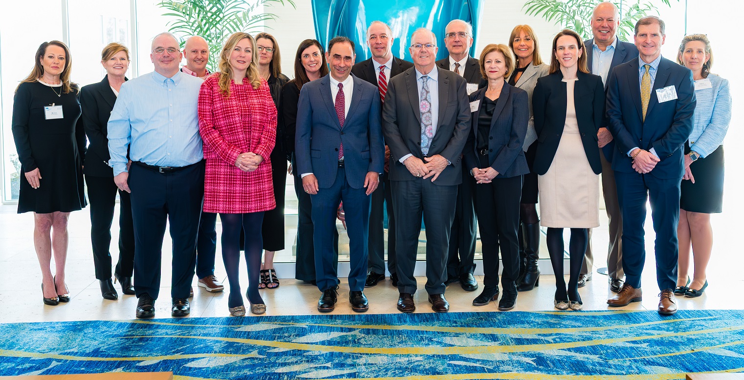 Alan McKim and his family, along with members of South Shore Health's Board of Directors and Senior Leadership Team, pose for a group photo