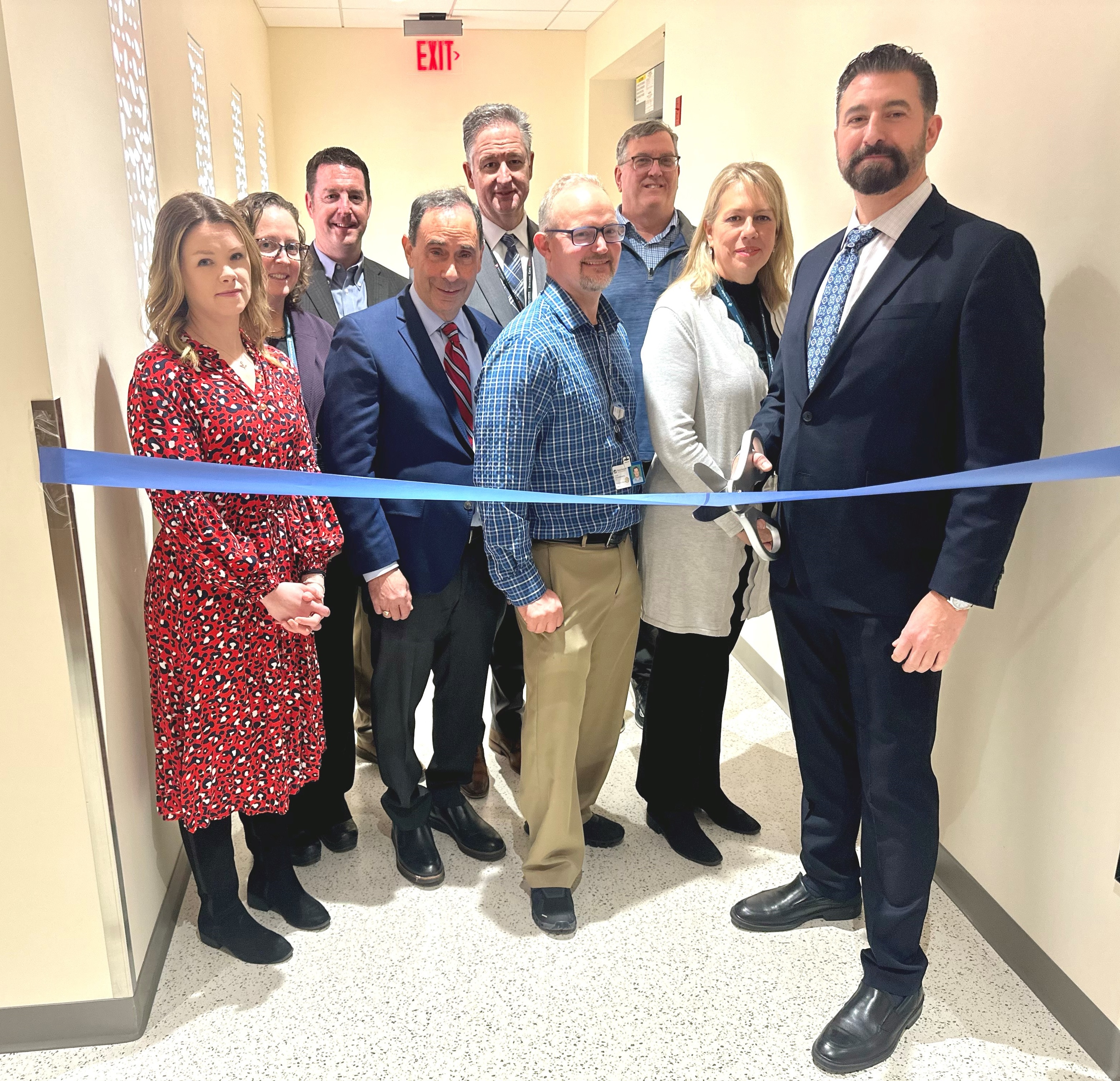 Dr. Peter Orio (far right) cuts the ribbon to officially open the new treatment suite
