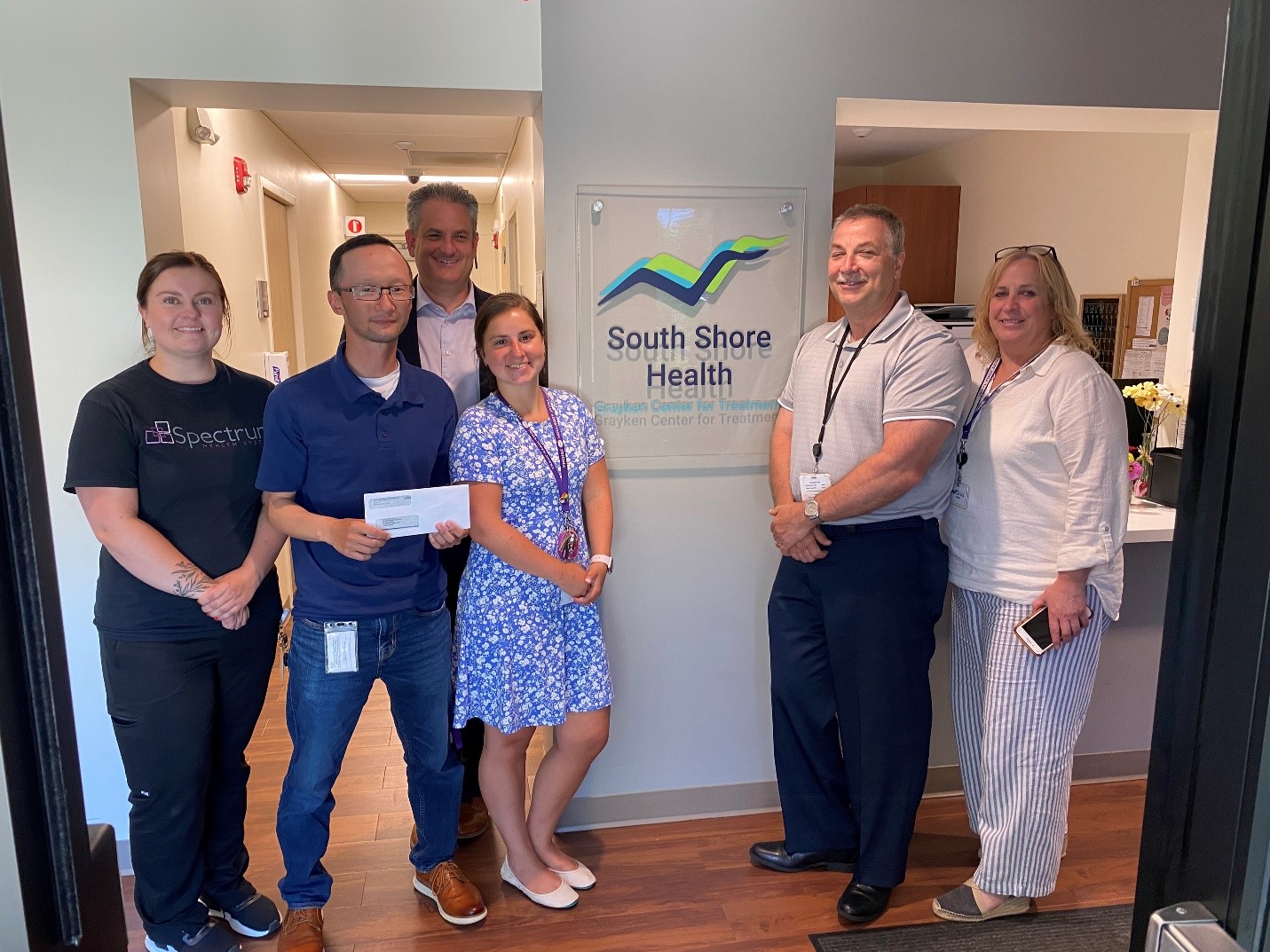 Six members of South Shore Health and Spectrum Health Systems pose for a photo after Spectrum's recent grant.