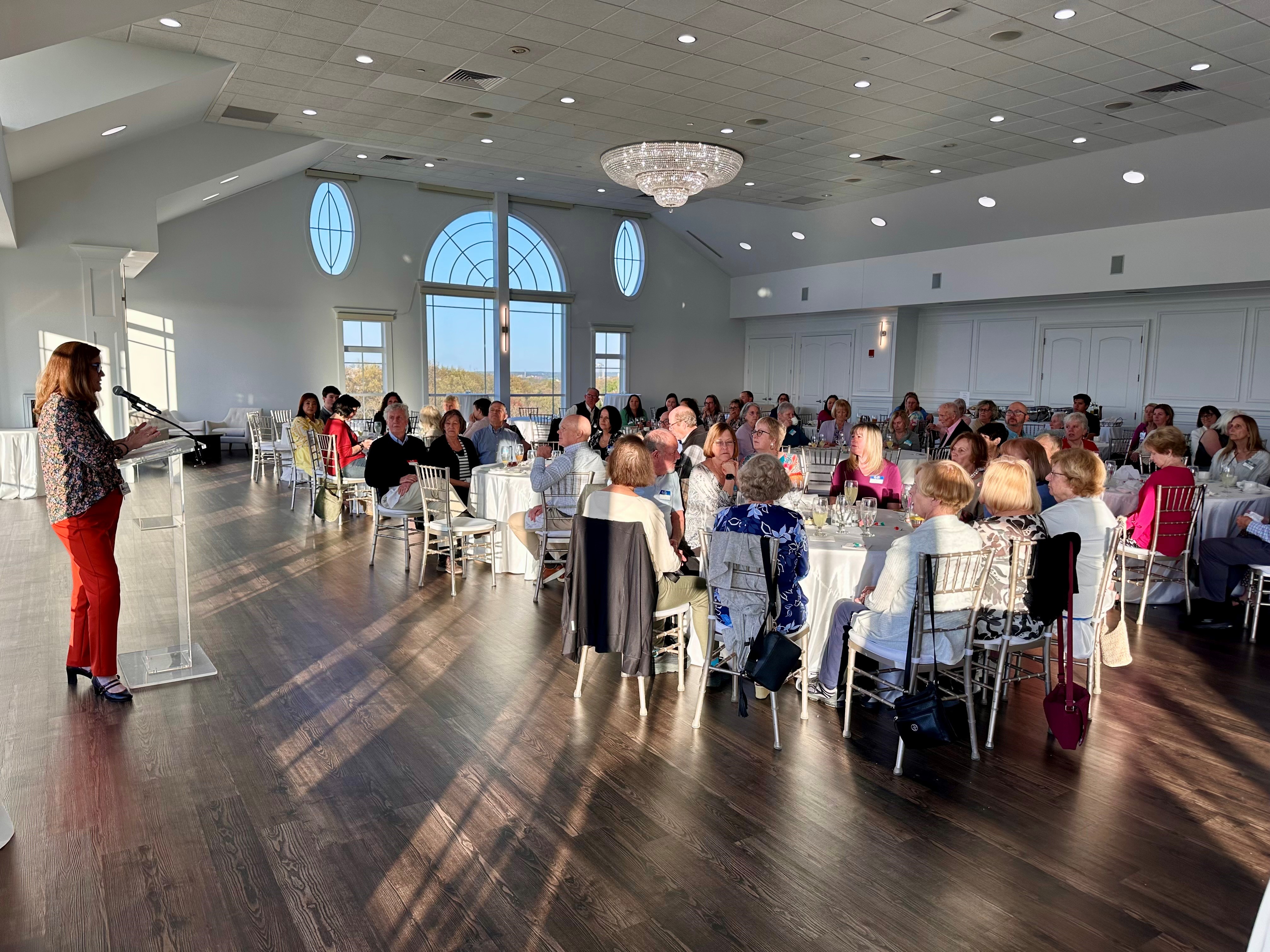 A shot of a ballroom at Granite Links in Quincy as Amy Parker speaks at the podium at South Shore Health's Volunteer Appreciation Dinner