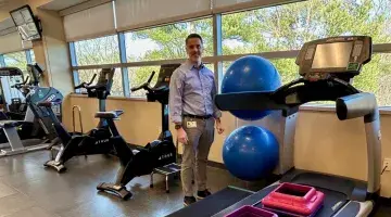 Rehabilitation Manager Dan Murray stands by a treadmill at Physical Therapy and Wellness