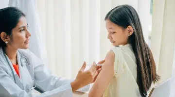 A doctor administers an HPV vaccine to a young girl