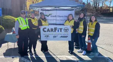 South Shore Health colleagues pose for a group photo during their November CarFit event.