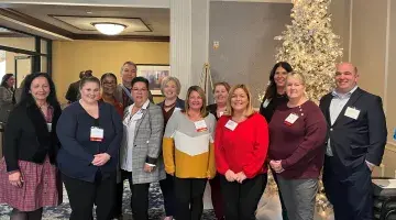 Several nurse leader colleagues pose for a photo at a December 2023 Organization of Nurse Leaders meeting.