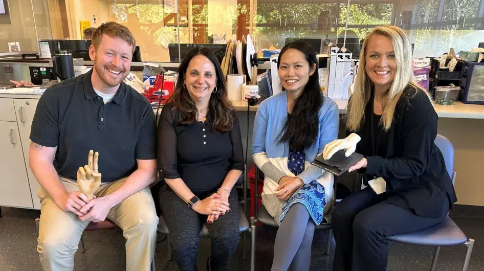 Four certified hand therapists from South Shore Health pose for a group photo.