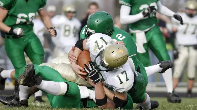 A football player is tackled during a game