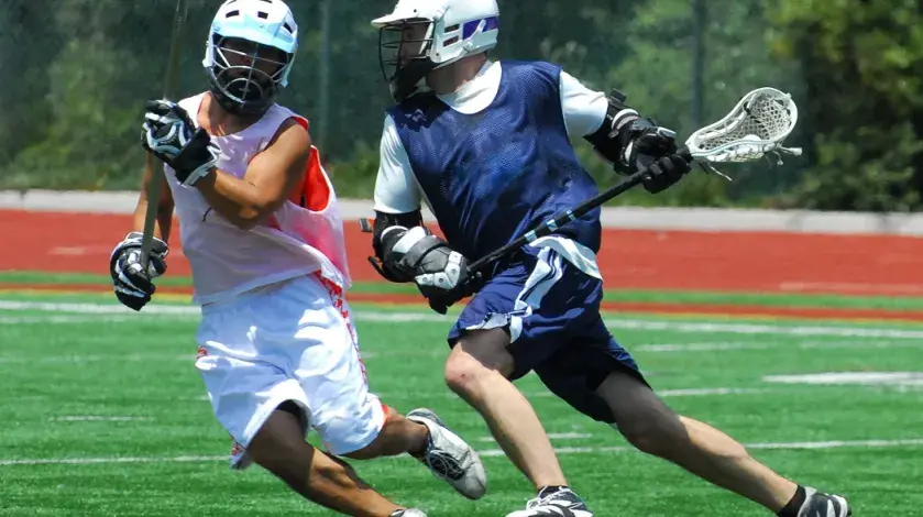 Two male athletes playing a lacrosse game