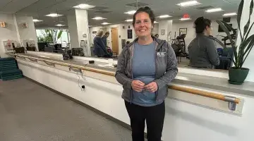 Community Exercise Manager Jennifer Logan stands by the mirror in class