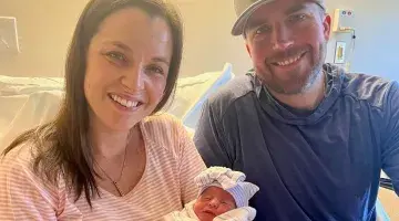 Woman and man holding newborn baby