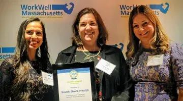 Joanne King accepts the statewide colleague wellness award on behalf of South Shore Health