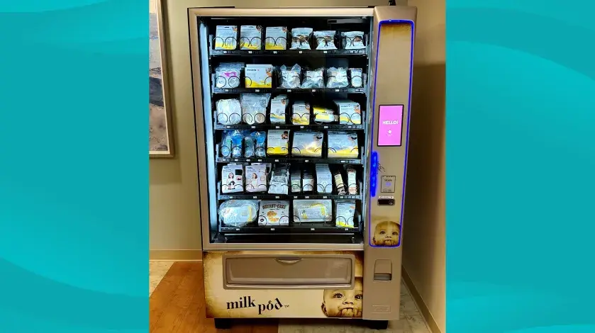 South Shore Hospital's milkpod machine, fully stocked with items, on an aqua patterned background