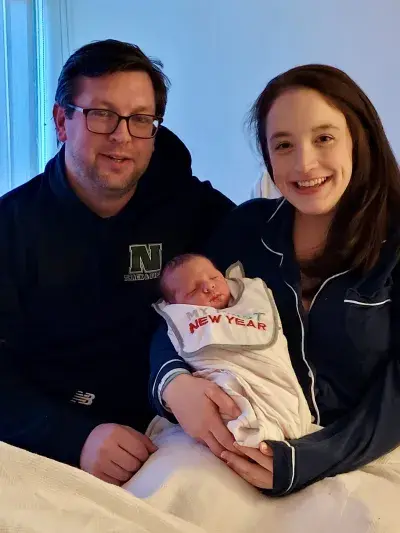 A couple holding their newborn baby